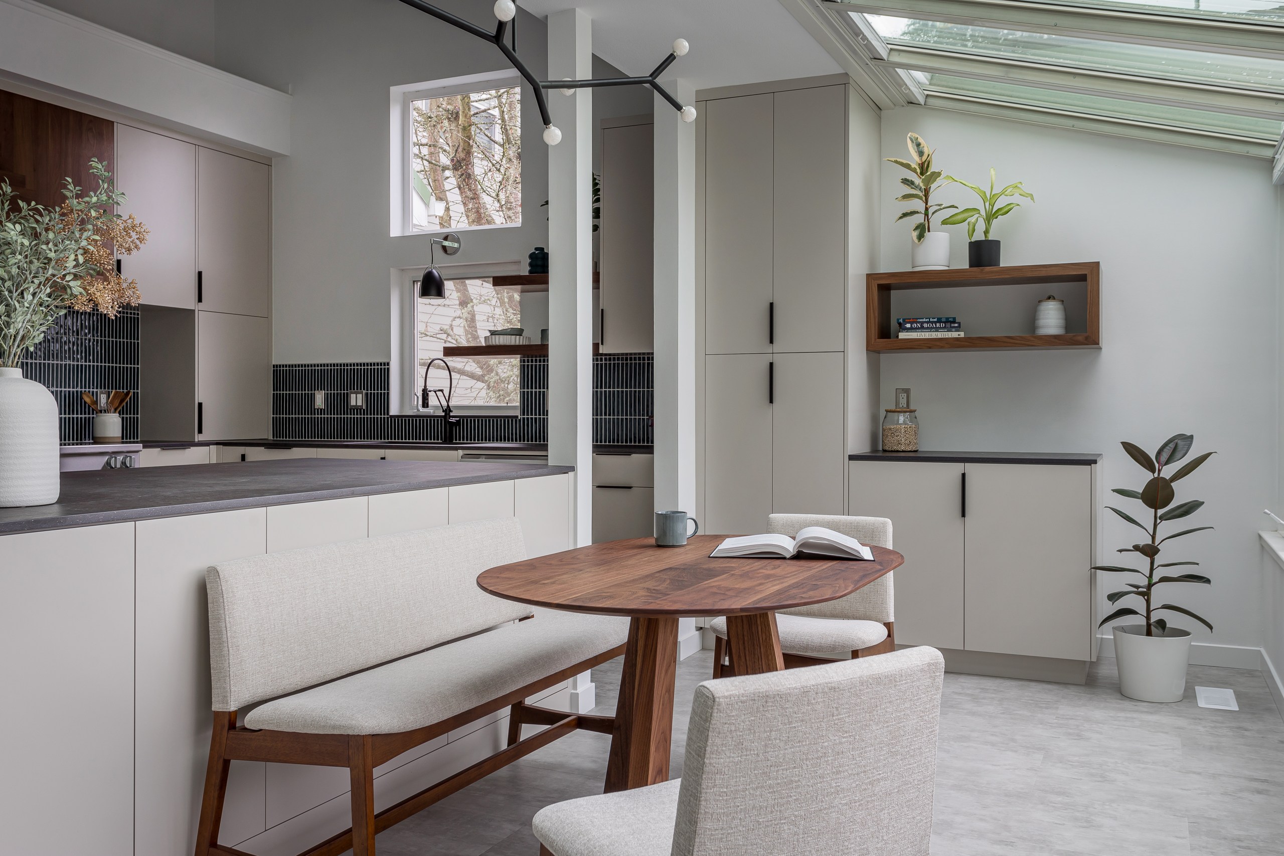 Final kitchen reveal showing warm wood tones, clean cabinetry lines, and thoughtful design